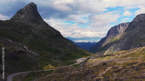 drone view capturing the dramatic canyon topography and winding road route of Trollstigen in Møre og Romsdal, Norway