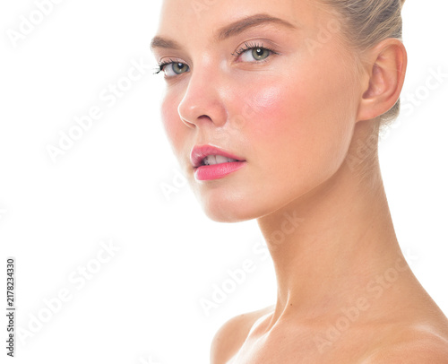Beautiful face of young adult woman with clean fresh skin. Looking at Camera.