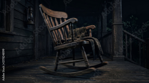 Empty wooden rocking chair moving on a dark rustic porch at night