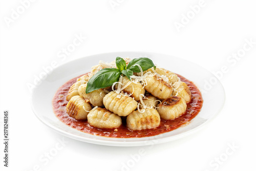 Fresh potato gnocchi with red tomato sauce and green basil