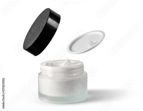 Open jar of white cosmetic cream with floating lid and inner seal over white background, with cream, cosmetic