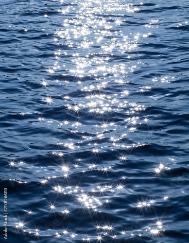 Sun glitter sparkling off the sea water surface