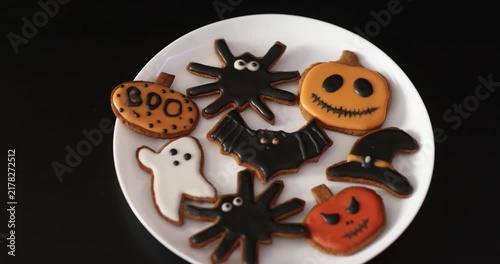 Lots of Halloween gingerbread cookies in a plate on a dark background. Homemade Halloween gingerbread cookies
