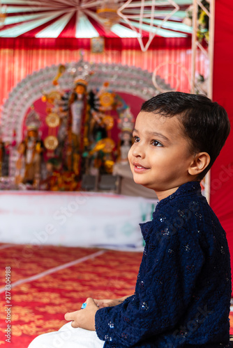 Hindu Boy Showing cute Devotion During Durga Puja Celebration