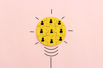 Wooden cubes with people icons over pastel background, human resources and management concept