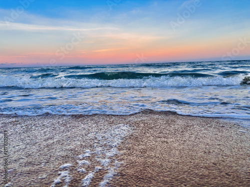фотографія Ocean Waves on a Sandy Beach at Sunset