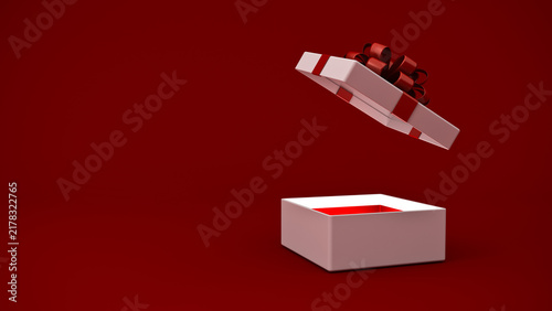 Blank white present box open or gift box with red ribbons and bow isolated over dark red background with light coming out of the box and blank copy space minimal conceptual 3D rendering