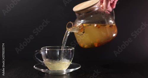 aromatic sea buckthorn vitamin tea on a dark background
