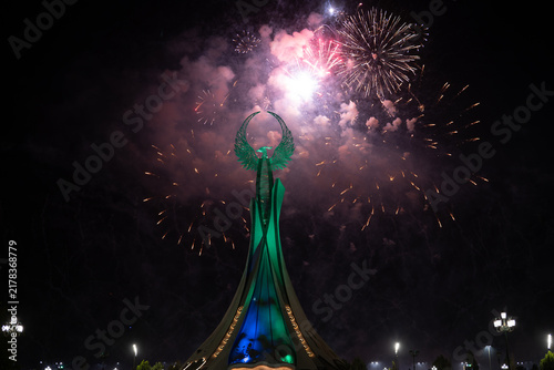 Spectacular colorful fireworks illuminating the Humo Bird Stella in Yangi Uzbekistan, Tashkent, Uzbekistan, at night. Dramatic festive scene featuring the iconic national symbol against a vibrant illu