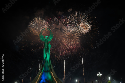 Spectacular colorful fireworks illuminating the Humo Bird Stella in Yangi Uzbekistan, Tashkent, Uzbekistan, at night. Dramatic festive scene featuring the iconic national symbol against a vibrant illu
