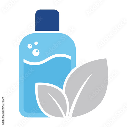 Bottle of blue liquid with gray leaves and dark blue cap on white background closeup