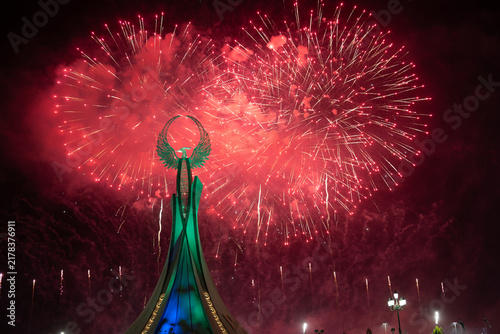 Spectacular colorful fireworks illuminating the Humo Bird Stella in Yangi Uzbekistan, Tashkent, Uzbekistan, at night. Dramatic festive scene featuring the iconic national symbol against a vibrant illu
