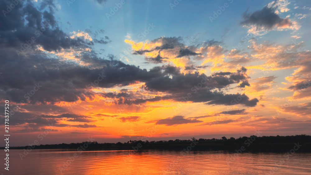 Obraz premium sunset over the river