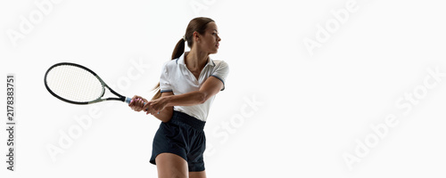 Fotografía Female tennis player making compact backhand return on white studio background