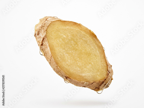 Fresh raw ginger root slice with water drops on white background