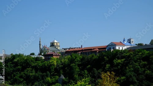 Historic Old Town Skyline of Kamianets Podilskyi with Saints Peter and Paul Cathedral and Minaret Rising Above Green Smotrych Canyon in Ukraine