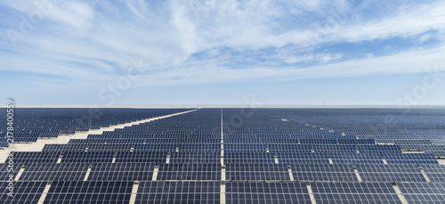 Aerial View of Endless Solar Panel Array Stretching Across Vast Desert Landscape