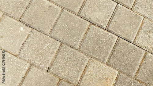 Diagonal beige square concrete paving blocks seamless pattern background