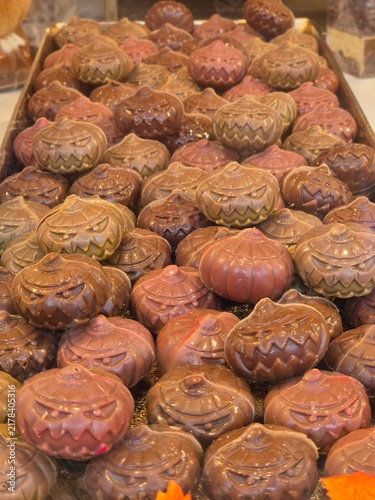 Сhocolate jack-o-lanterns displayed in rows for Halloween