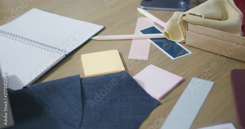Camera is recording, focusing, nudging frame right, showing navy swatch on table for design review