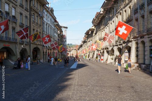 Obraz na plátně Sunlight bathes a cobblestone street lined with historic buildings