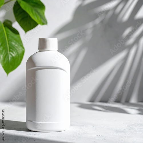 Blank white plastic bottle packaging mockup for skincare or cosmetic product, natural leaves shadow, sustainable beauty brand