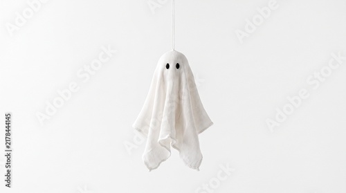 Hanging ghost decoration made from white fabric with black eyes  