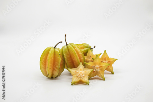 Fresh whole and sliced starfruit on a surface