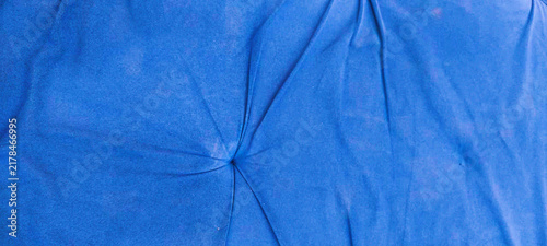 Vibrant blue fabric texture with soft wrinkles, crumpled cobalt textile background, draped linen cloth material for design