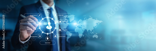 Fotografía Corporate strategist reviewing business plans pointing toward Management Consulting strategies over the global network ecosystem
