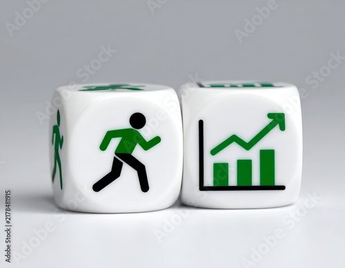 Two dice with green icons depicting a person running and a rising graph, on a white surface