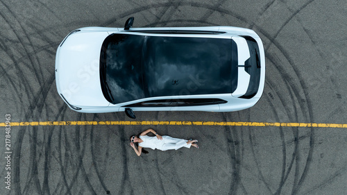 Top view of white ev car.
New ev car on tire marks.
Fast ev car parked on road.