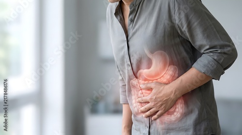 Woman suffering from abdominal pain with stomach and intestine graphic overlay