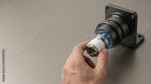 Obraz w ramie Human hand inserting task module into interchangeable end-effector chuck representing robotics-as-a-service flexibility