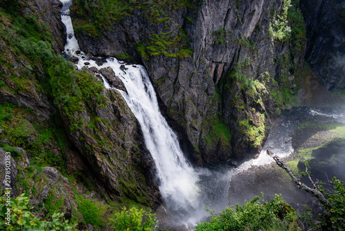 Obraz na płótnie Dramatic Waterfall Flowing Down a Steep Mountain Canyon