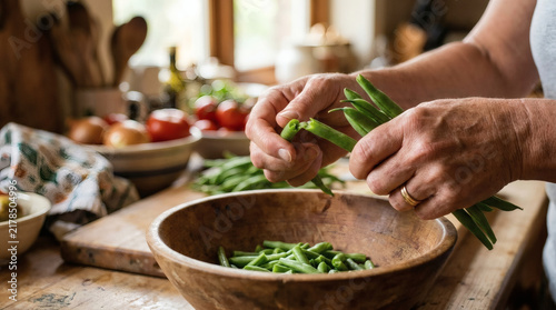 Hands preparing fresh green beans in a rustic kitchen setting
