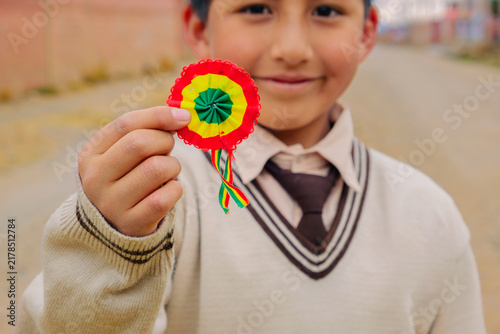 Bolivian boy in a school uniform holding a Bolivian cockade - concept of education