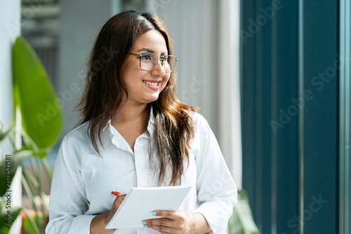 Obraz na plátne Professional woman smiling envisioning future business success