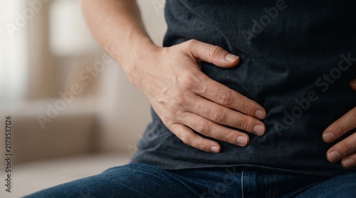 Man holding his stomach in pain close up