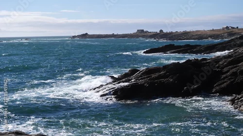 rough sea waves crashing against dark rocky coast in wild landscape