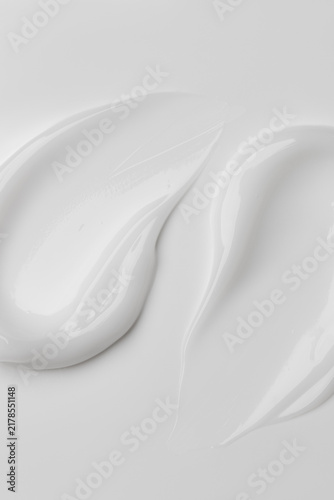 White cosmetic cream double swirl swipes with brush strokes vertical macro texture