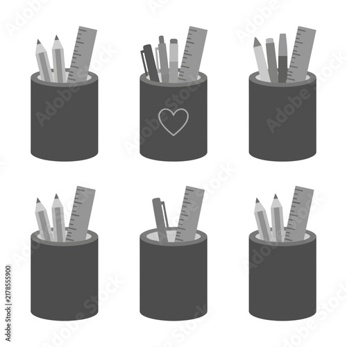 Pencils and rulers in dark gray desk pen holders with heart design