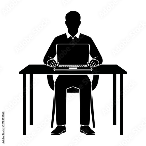 Man sitting at desk working on laptop computer in office