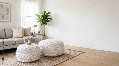Modern minimalist living room with white knitted poufs and empty wall space