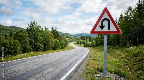Scenic Road With U-Turn Sign Surrounded By Lush Greenery