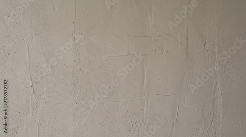 Plain concrete wall texture with subtle cracks and soft neutral tones