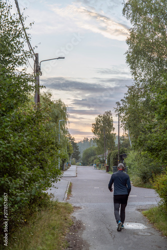 Photography man walking on the misty road in the city, nacka,sverige,sweden,stockholm,summer