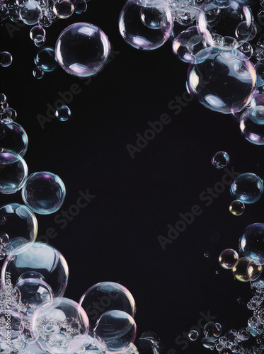 Iridescent Soap Bubbles Framing Black Background With Space for Copy, Floating Transparent Spheres