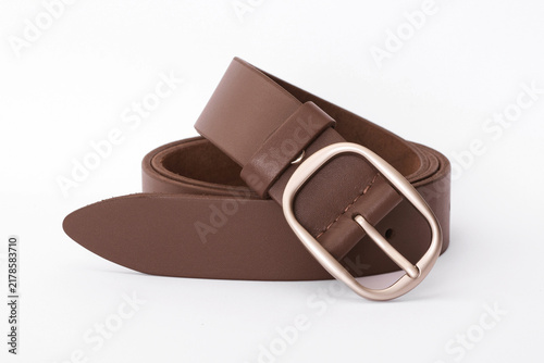 Brown smooth leather belt coiled with an oval metallic buckle isolated on a white background