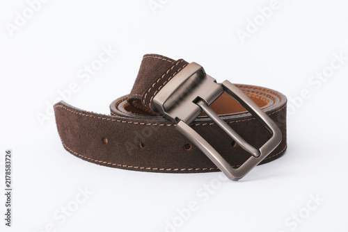 Dark brown suede leather belt coiled with a matte silver metal buckle on a white background